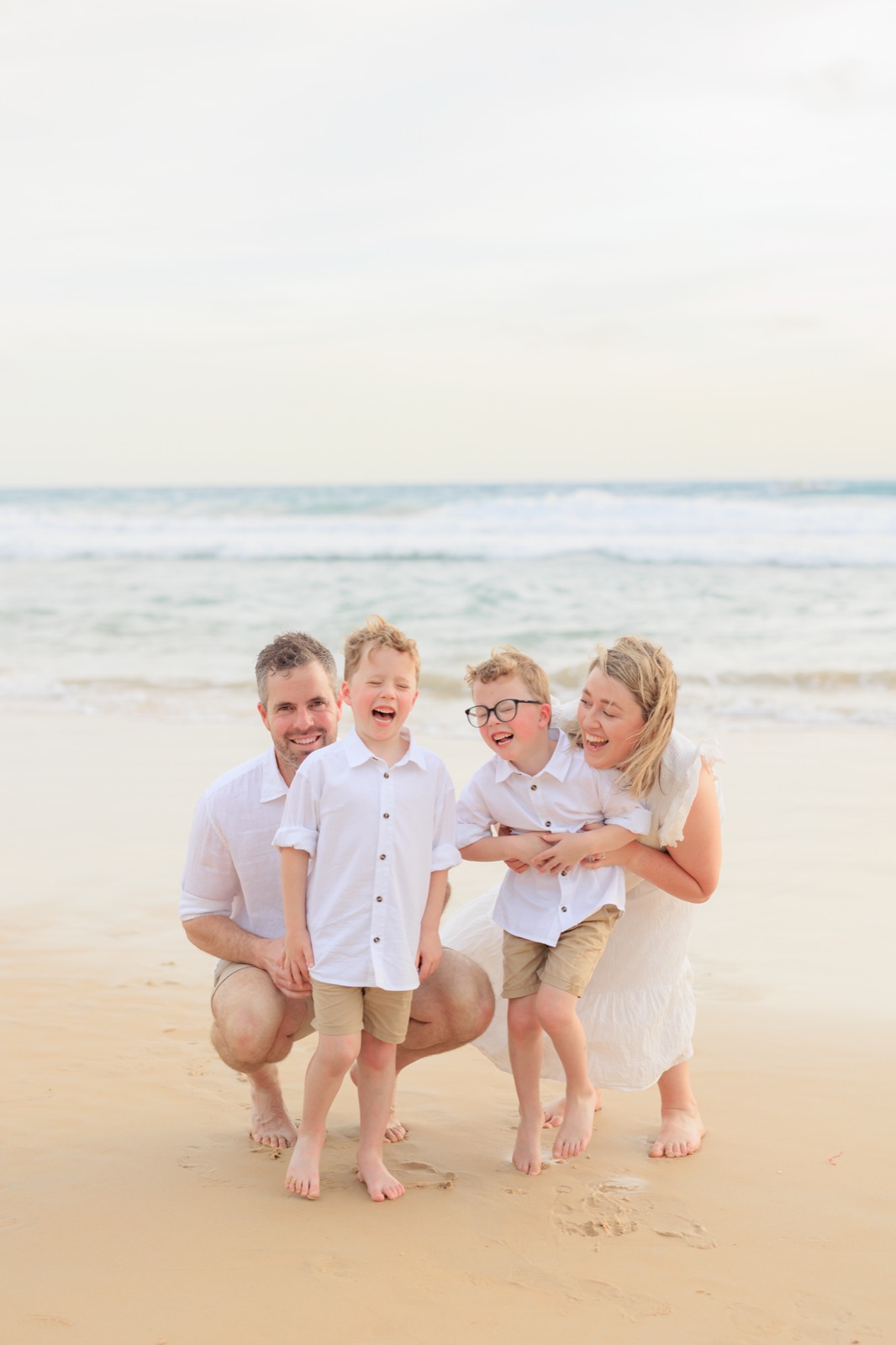 Lauren and her family laughing together on the beach