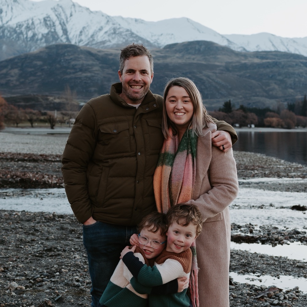 Lauren and her family in front of snowy mountains in New Zealand